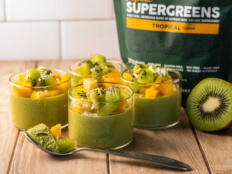 Creamy tropical Supergreens panna cotta topped with fresh kiwi and mango, made with Paleovalley Organic Supergreens and coconut milk; dairy-free, sugar-free, and paleo-friendly.